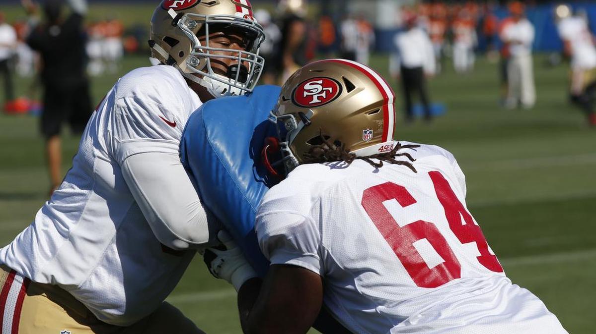 San Francisco 49ers offensive guard Joshua Garnett, left, jostles with offensive tackle Fahn Cooper during drills before facing the Denver Broncos at the teams' NFL football training camp session Wednesday, Aug. 17, 2016 in Englewood, Colo.
