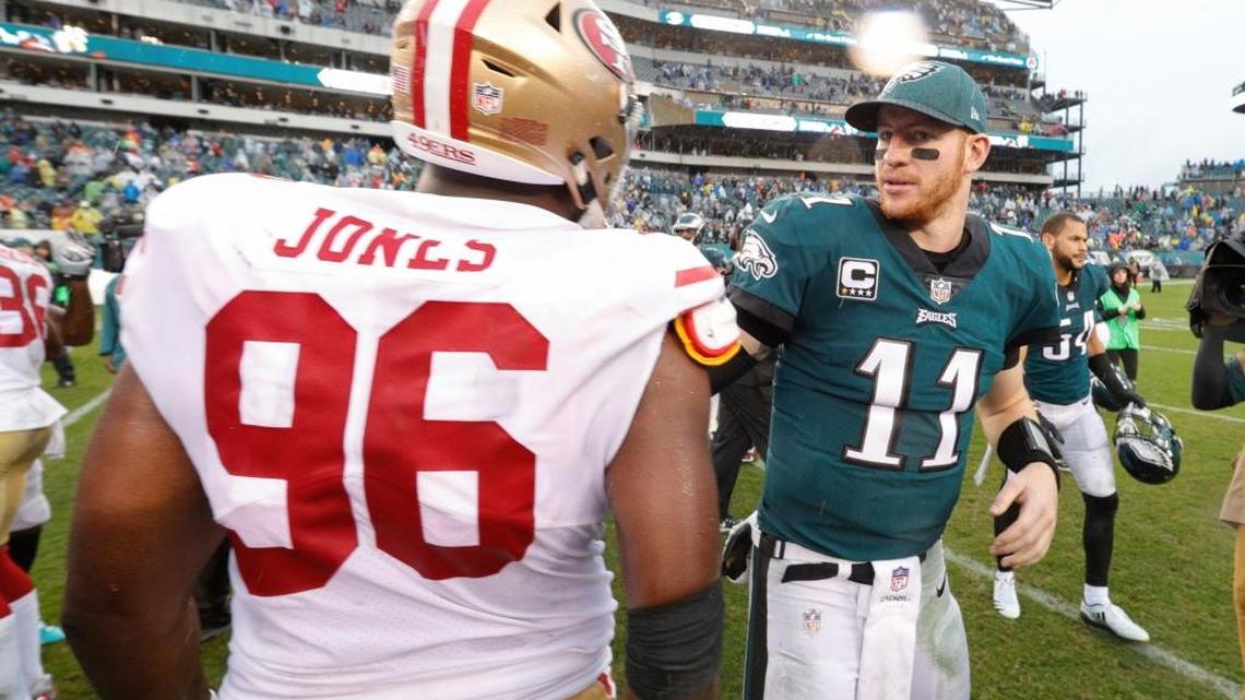 Philadelphia Eagles quarterback Carson Wentz talks with San Francisco 49ers defensive end Datone Jones during an NFL football game, Sunday, Oct. 29, 2017, in Philadelphia.