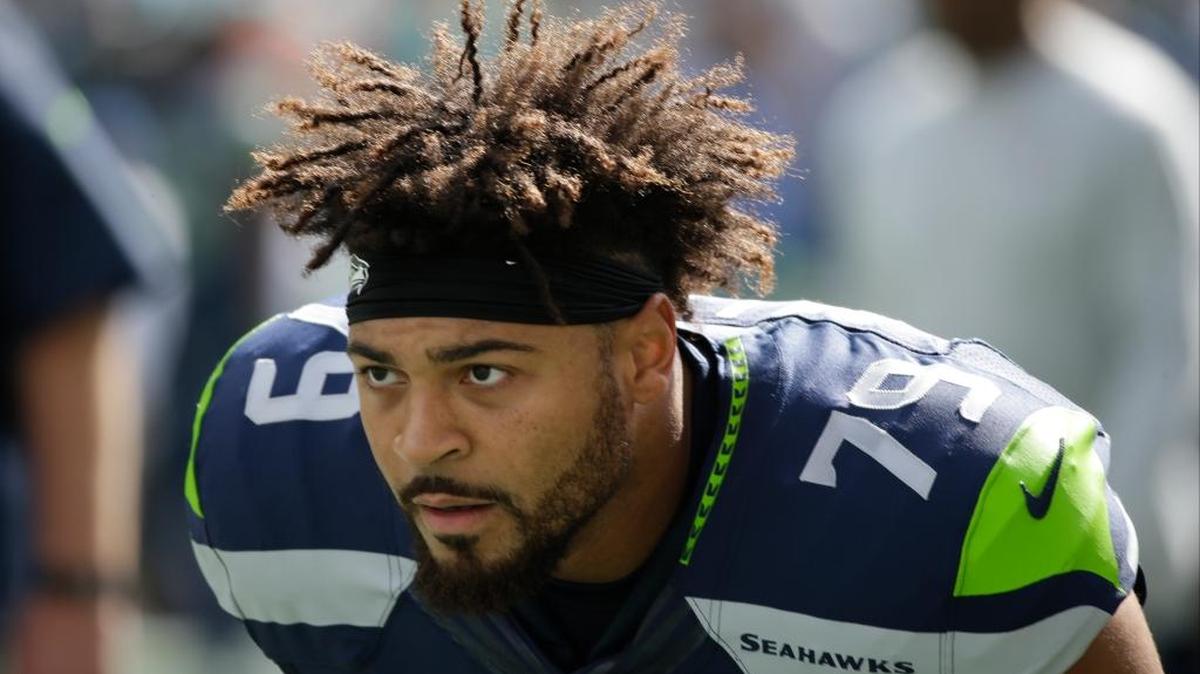 Seattle Seahawks tackle Garry Gilliam stretches during warmups before an NFL football game against the Miami Dolphins, Sunday, Sept. 11, 2016, in Seattle.