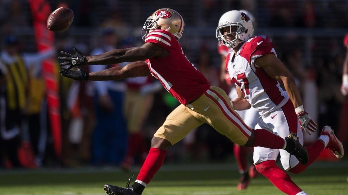 Marquise Goodwin, left, reaches for an incomplete pass while being covered by the Arizona Cardinals’ Tyvon Branch during the 49ers’ 20-10 loss Sunday at Levi’s Stadium.