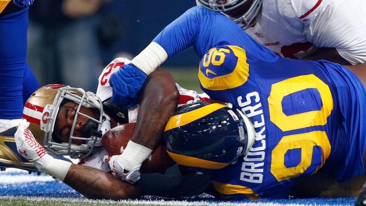San Francisco 49ers running back Mike Davis, left, is tackled in the end zone by St. Louis Rams defensive tackle Michael Brockers for a safety during the first quarter of an NFL football game Sunday, Nov. 1, 2015, in St. Louis.