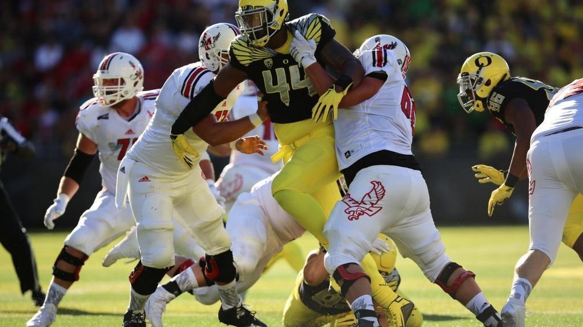 Oregon defensive lineman DeForest Buckner (44) breaks through the offensive line during the first half of an NCAA college football game against Eastern Washington Saturday, Sept. 5, 2015, in Eugene, Ore.