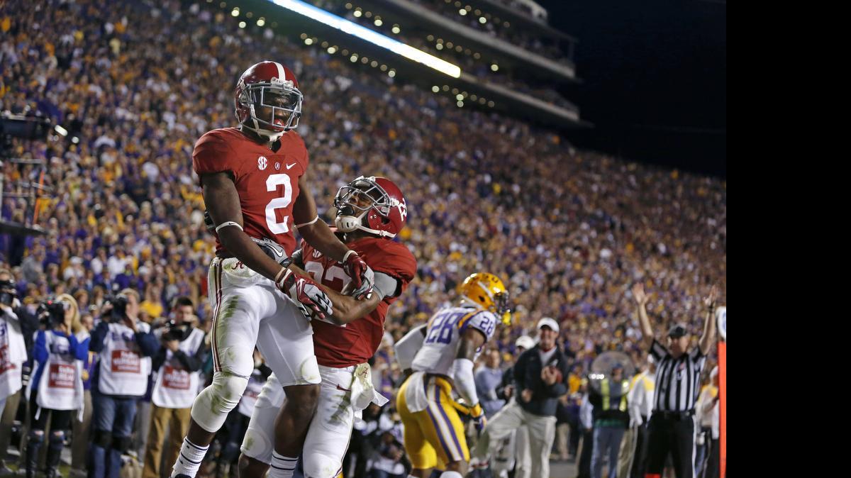 
Alabama wide receiver DeAndrew White (2) celebrates his game winning touchdown with wide receiver Christion Jones (22) in the second half of an NCAA college football game against LSU in Baton Rouge, La., Saturday, Nov. 8, 2014. Alabama won in overtime 20-13.  
