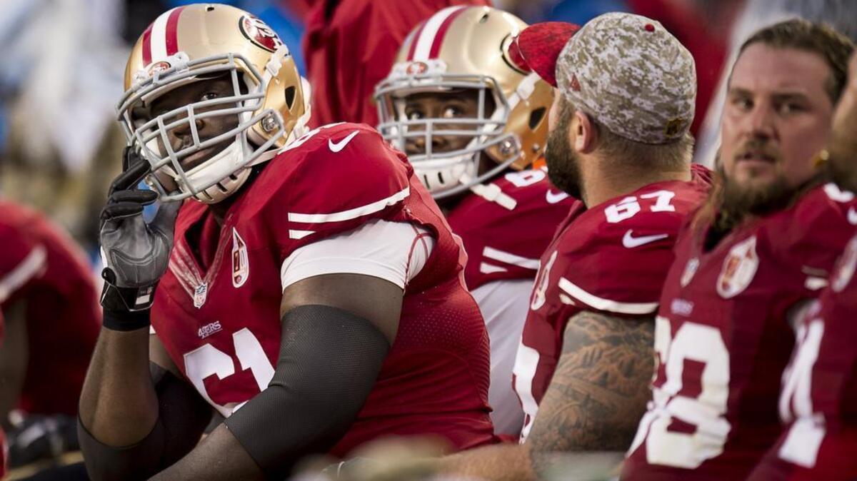 San Francisco 49ers guard Andrew Tiller, left, looks at the scoreboard in the final minutes of the game against the New England Patriots at Levi’s Stadium on Sunday, November 20, 2016 in Santa Clara, Calif. The Patriots won 30-17.