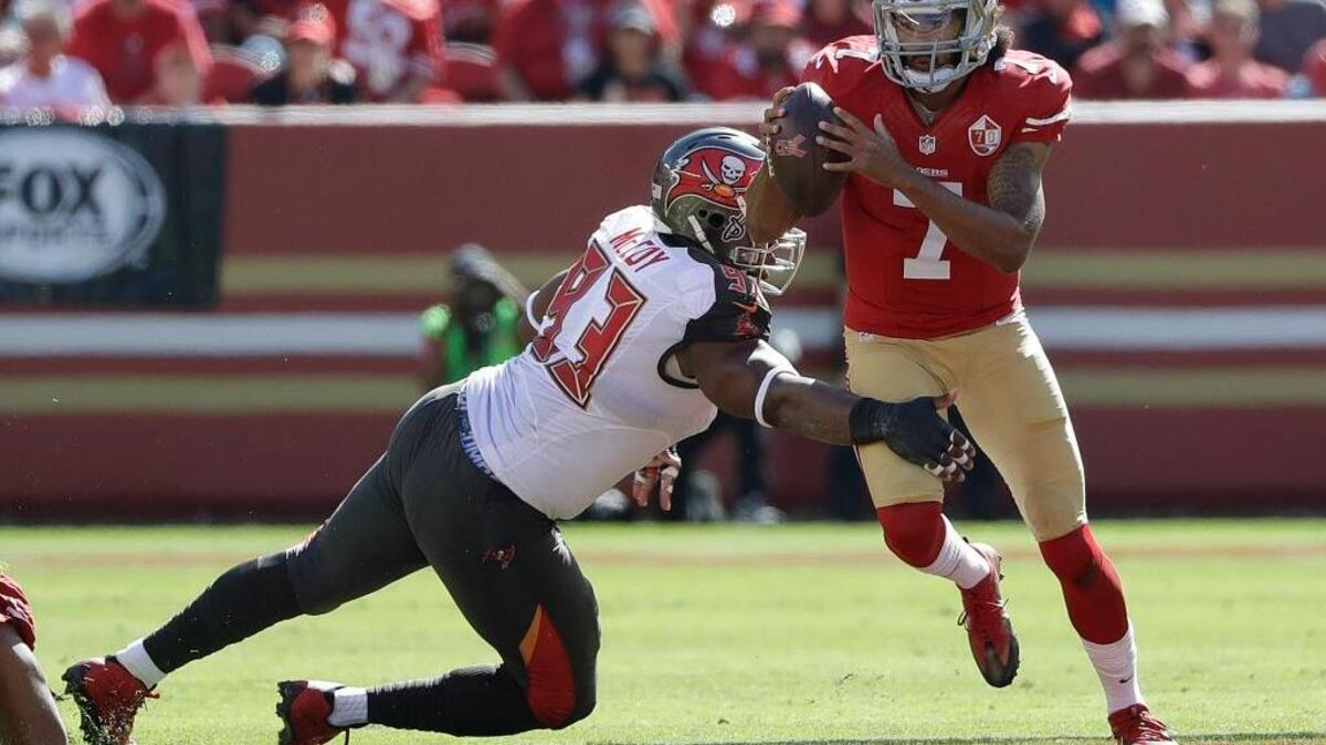 San Francisco 49ers quarterback Colin Kaepernick (7) scrambles away from Tampa Bay Buccaneers defensive tackle Gerald McCoy (93) during the first half of an NFL football game in Santa Clara, Calif., Sunday, Oct. 23, 2016.