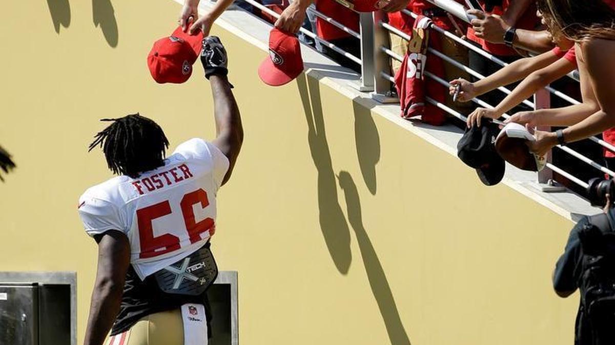 San Francisco 49ers' Reuben Foster signs autographs for fans before practicing at an NFL football training camp in Santa Clara, Calif., Saturday, Aug. 5, 2017.