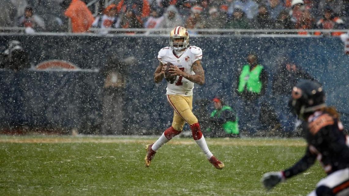San Francisco 49ers quarterback Colin Kaepernick (7) rolls out as he looks for a receiver during the second half of an NFL football game against the Chicago Bears, Sunday, Dec. 4, 2016, in Chicago.