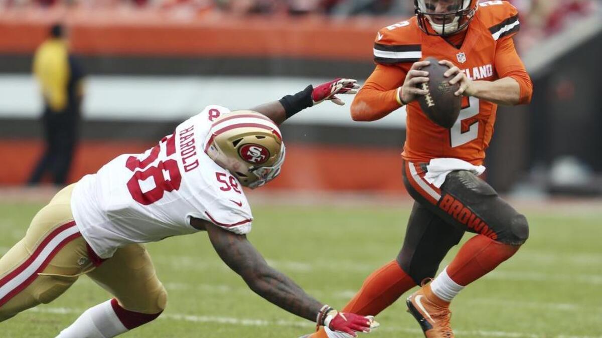 Cleveland Browns quarterback Johnny Manziel (2) scrambles from San Francisco 49ers outside linebacker Eli Harold (58) during the first half of an NFL football game, Sunday, Dec. 13, 2015, in Cleveland.