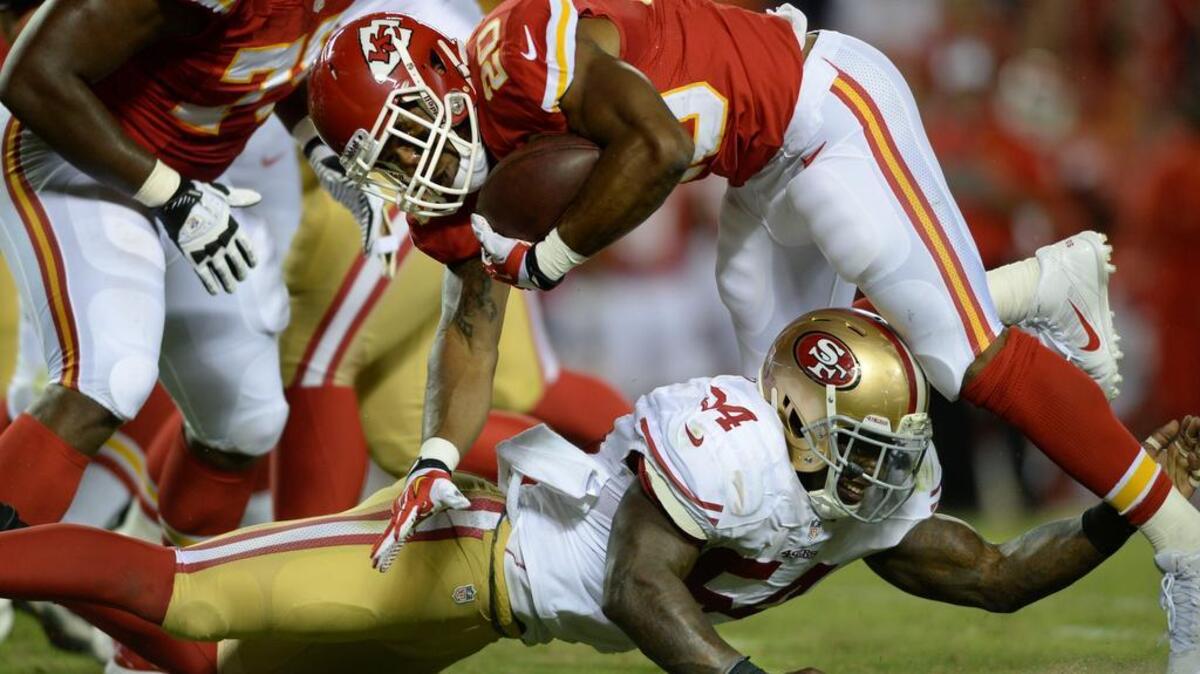 
Running back Shaun Draughn (20) is tackled by San Francisco 49ers outside linebacker Nick Moody (54) during a preseason NFL football game in Kansas City, Mo., Friday, Aug. 16, 2013.
