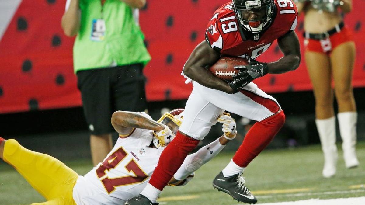 Atlanta Falcons wide receiver Aldrick Robinson (19) breaks the tackle of Washington Redskins cornerback Quinton Dunbar (47) during the first half of a preseason NFL football game, Thursday, Aug. 11, 2016, in Atlanta.