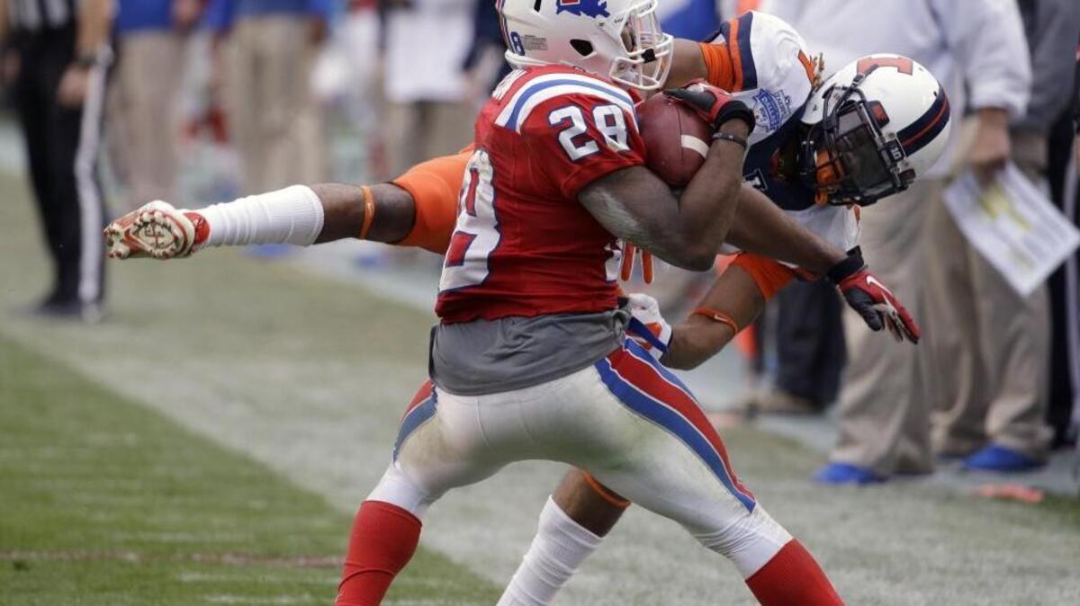 Louisiana Tech running back Kenneth Dixon (28) catches a pass then steps out of bounds against Illinois defensive back Earnest Thomas III (9) during the second half of the Heart of Dallas Bowl NCAA college football game Friday, Dec. 26, 2014, in Dallas. Louisiana Tech won 38-15.