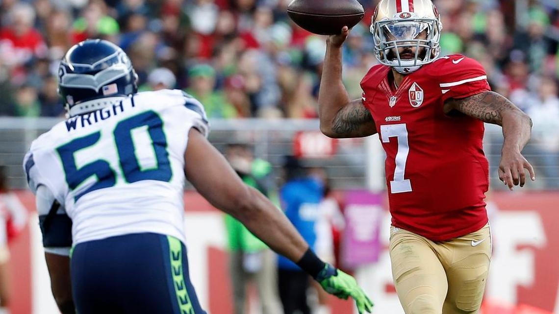 Colin Kaepernick, right, passes under pressure from Seattle outside linebacker K.J. Wright during the first half at Levi’s Stadium in Santa Clara, Calif., on Sunday, Jan. 1, 2017.