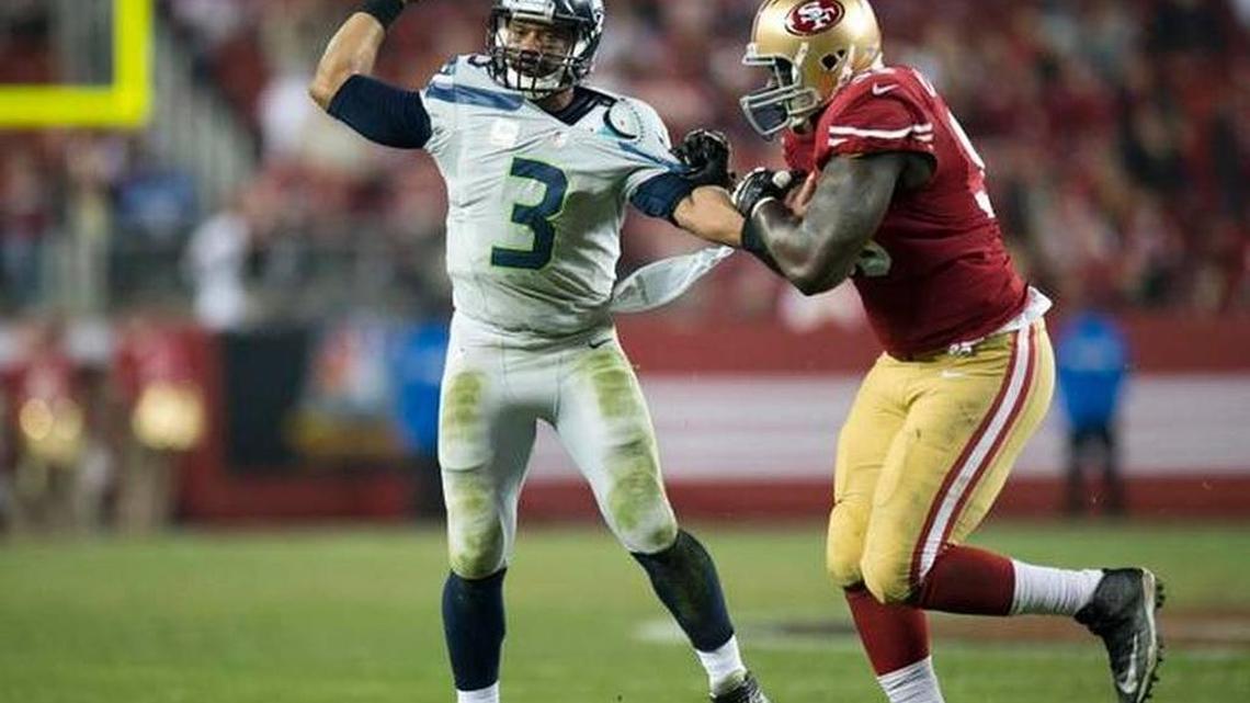 49ers defensive lineman Tank Carradine harasses Seahawks quarterback Russell Wilson in a game at Levi’s Stadium in 2014.