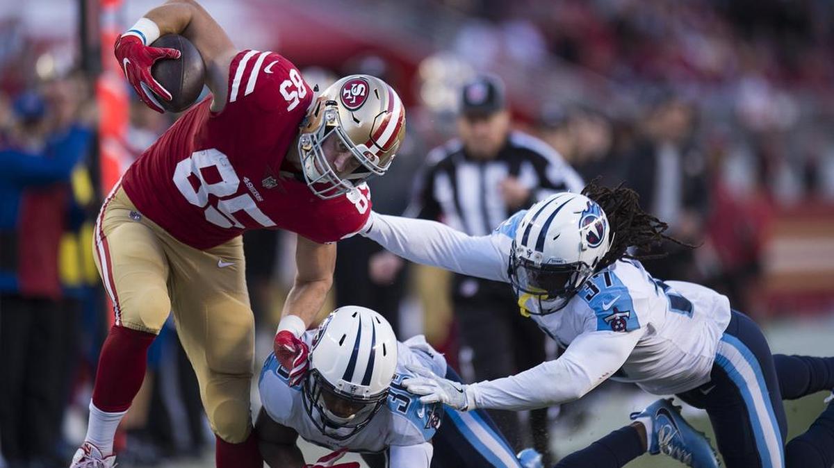 San Francisco 49ers tight end George Kittle (85) gains 19 yards as he breaks a tackle and runs out of bounds, chased by Tennessee Titans' LeShaun Sims (36) and Johnathan Cyprien (37) on the last drive in the fourth quarter during a game at Levi's Stadium in Santa Clara, Calif., on Sunday, December 17, 2017.