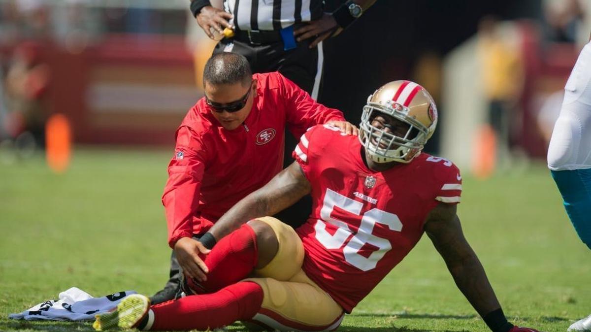 San Francisco 49ers Reuben Foster reaches for his injured right leg in the first quarter of the NFL season opener between the San Francisco 49ers and Carolina Panthers on Sunday, Sept. 10, 2017 at Levi’s Stadium in Santa Clara.