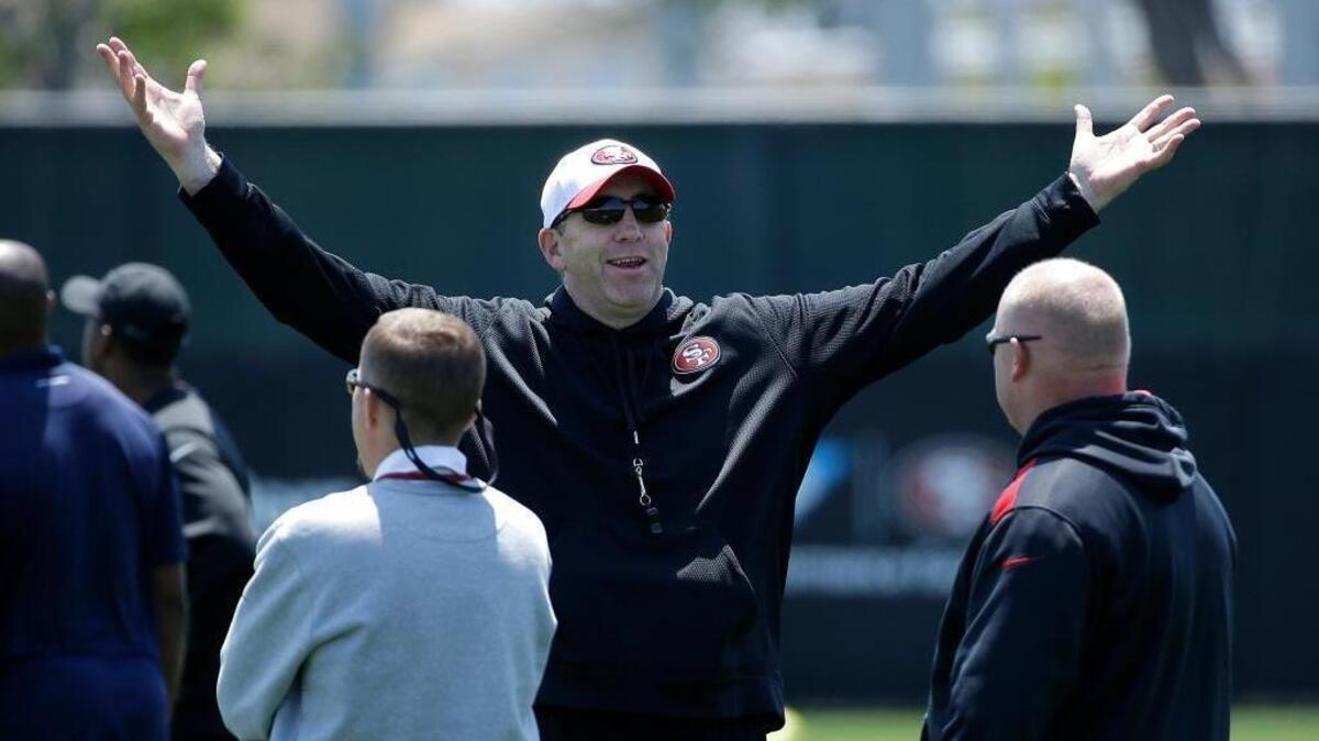 San Francisco 49ers offensive coordinator Geep Chryst, center, gestures at a football rookie minicamp at an NFL facility in Santa Clara, Calif., Friday, May 15, 2015.