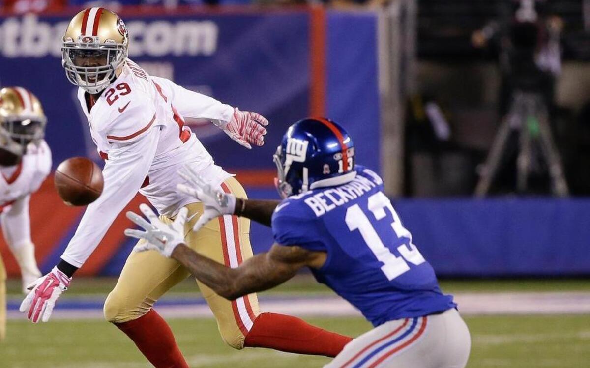 
New York Giants wide receiver Odell Beckham (13) makes a catch against San Francisco 49ers strong safety Jaquiski Tartt (29) during the second quarter of an NFL football game, Sunday, Oct. 11, 2015, in East Rutherford, N.J. 
