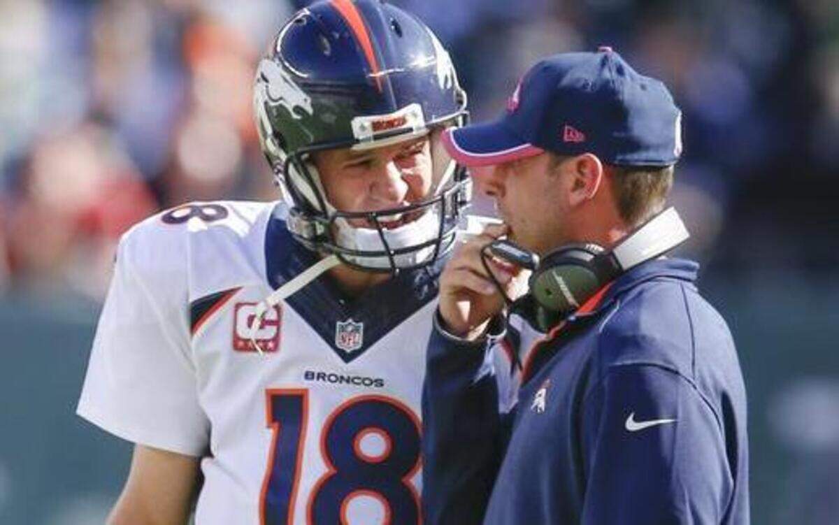 
Denver Broncos quarterback Peyton Manning, left, talks with offensive coordinator Adam Gase between plays during a 2014 game. Gase is a candidate for the San Francisco 49ers head coaching position and reportedly will have a second interview for the job.
