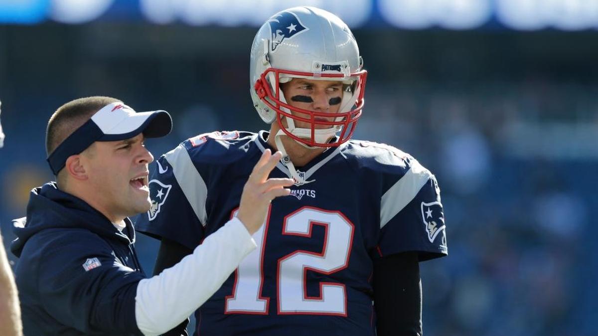 New England Patriots offensive coordinator Josh McDaniels talks with Tom Brady. The 49ers interviewed McDaniels for the head-coach opening last year and could add him to their final list of candidates this year.
