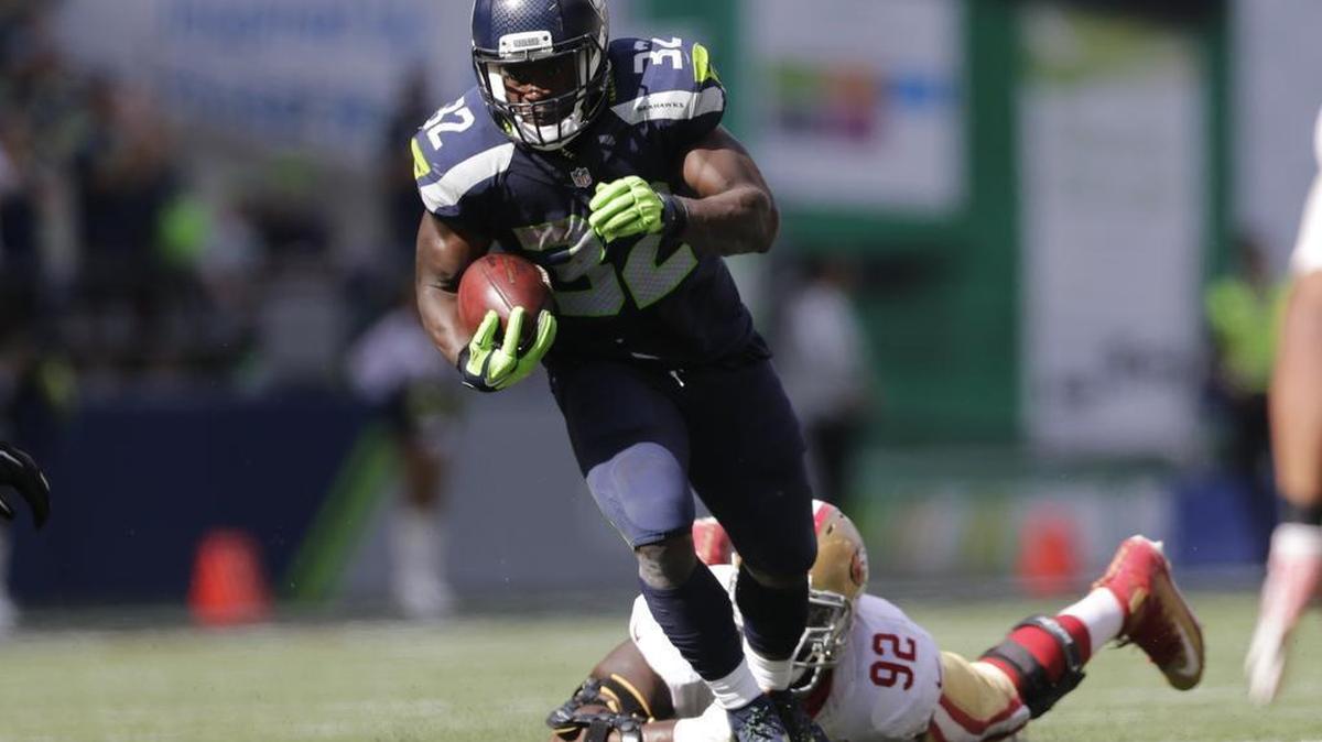 49ers’ defensive tackle Quinton Dial dove to the ground to try to stop Seattle’s Christine Michael in the first half of Sunday’s game in Seattle.