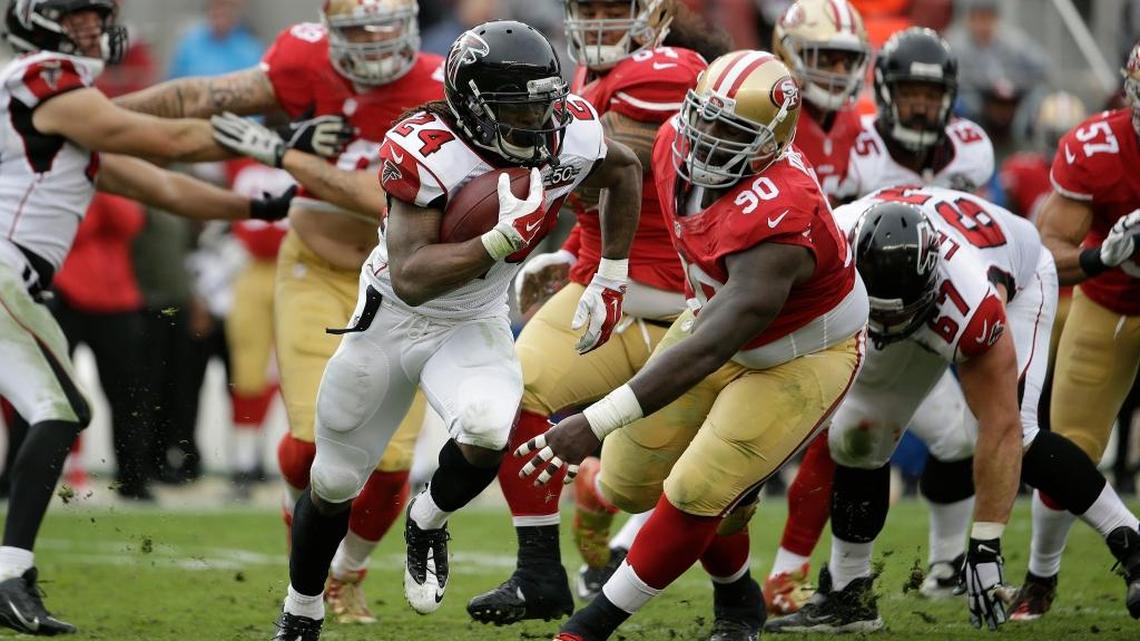 Atlanta Falcons running back Devonta Freeman (24) runs from San Francisco 49ers nose tackle Glenn Dorsey (90) during an NFL football game in Santa Clara, Calif., Sunday, Nov. 8, 2015.