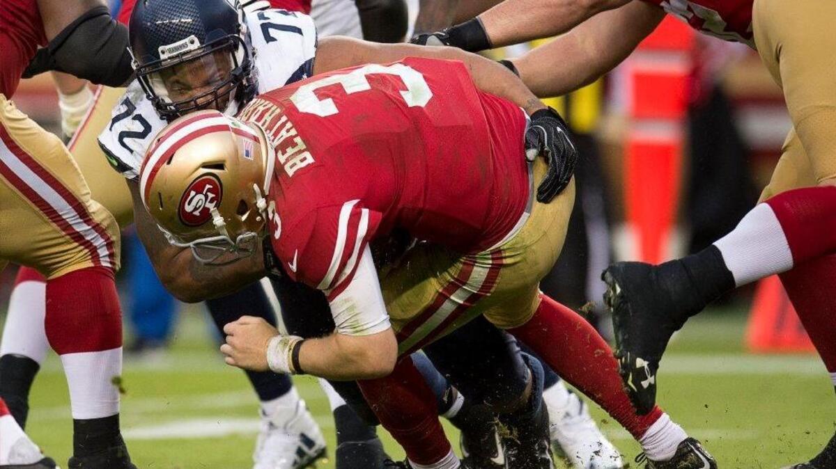 San Francisco 49ers quarterback C.J. Beathard (3) is tackled for a 7 yard loss by Seattle Seahawks defensive end Michael Bennett (72) in the fourth quarter during the game at Levi's Stadium in Santa Clara, Calif. on Sunday November 26, 2017.