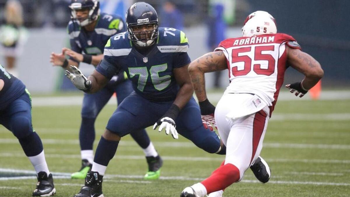 Seattle Seahawks' Russell Okung (76) defends against the Arizona Cardinals in the first half of an NFL football game, Sunday, Dec. 22, 2013, in Seattle.