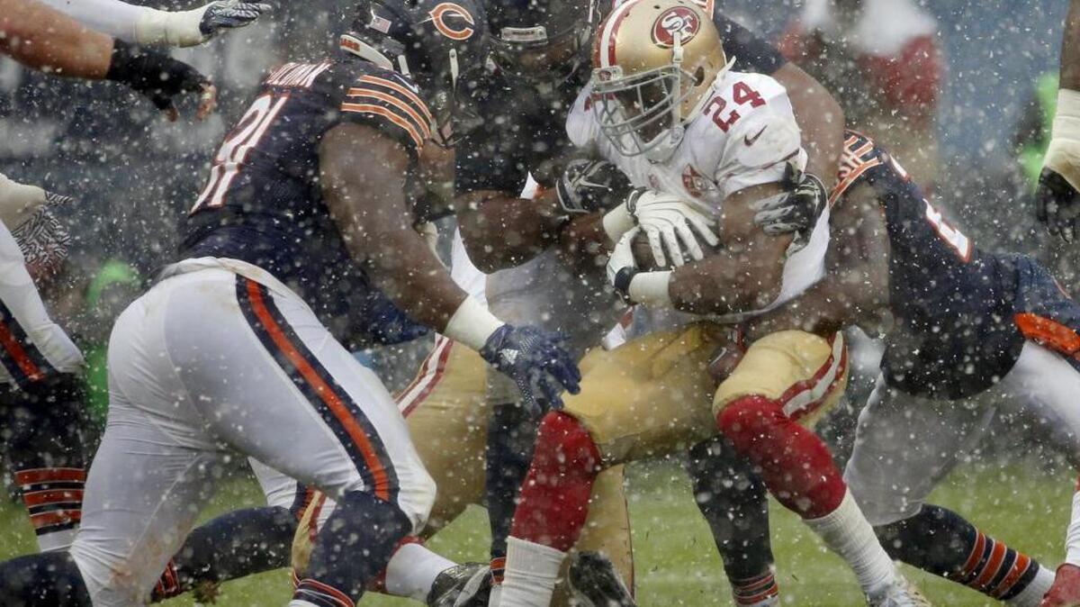 San Francisco 49ers running back Shaun Draughn (24) is tackled by Chicago Bears defenders during the first half of an NFL football game, Sunday, Dec. 4, 2016, in Chicago.