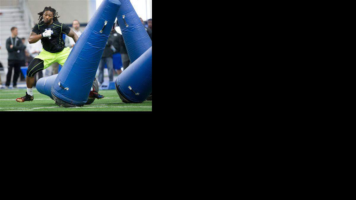 
Bud Dupree runs through drills during NFL football Pro Day at the University of Kentucky in Lexington, Ky., Thursday, March 12, 2015.
