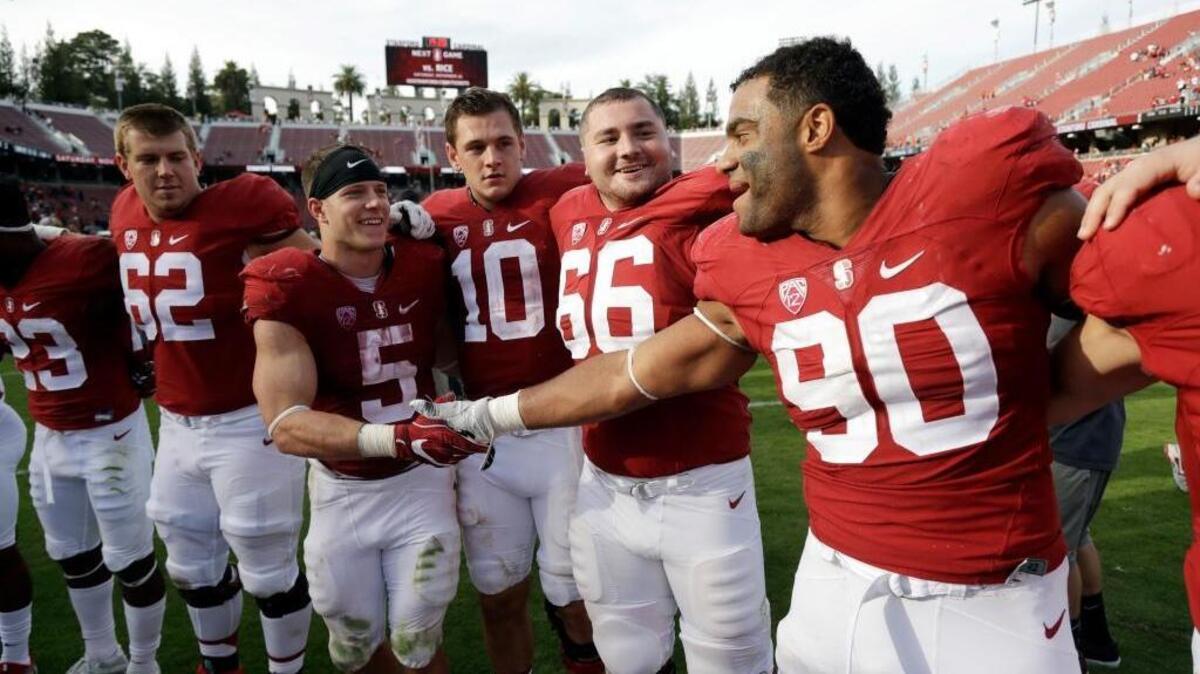 Stanford defensive end Solomon Thomas (90) shakes hands with running back Christian McCaffrey (5) at the end of an NCAA college football game against Oregon State Saturday, Nov. 5, 2016, in Stanford, Calif. Stanford won 26-15.