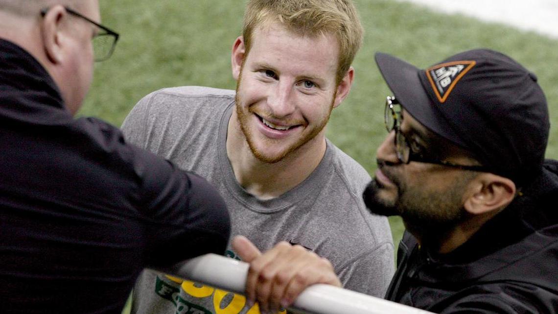 North Dakota State quaterback Carson Wentz, center, smiles after his workout at the school's NFL football pro day, Thursday, March 24, 2016, in Fargo, N.D.