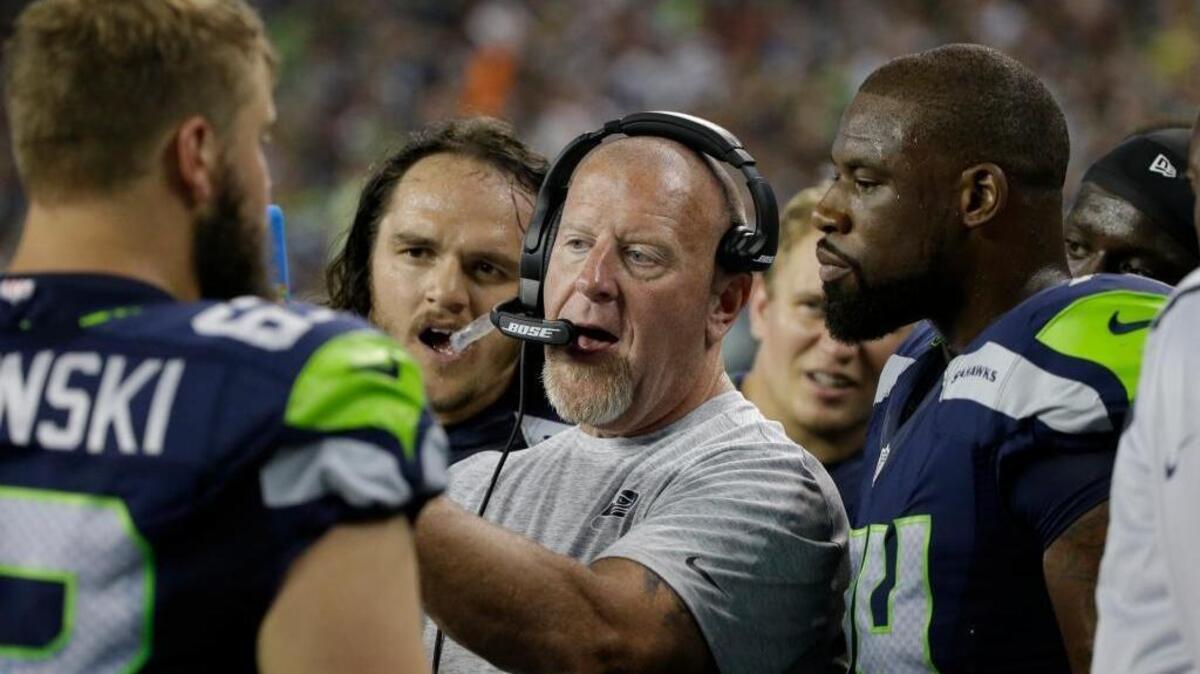 Seattle Seahawks assistant head coach and offensive line coach, talks to players during a preseason NFL football game against the Minnesota Vikings, Thursday, Aug. 18, 2016, in Seattle.