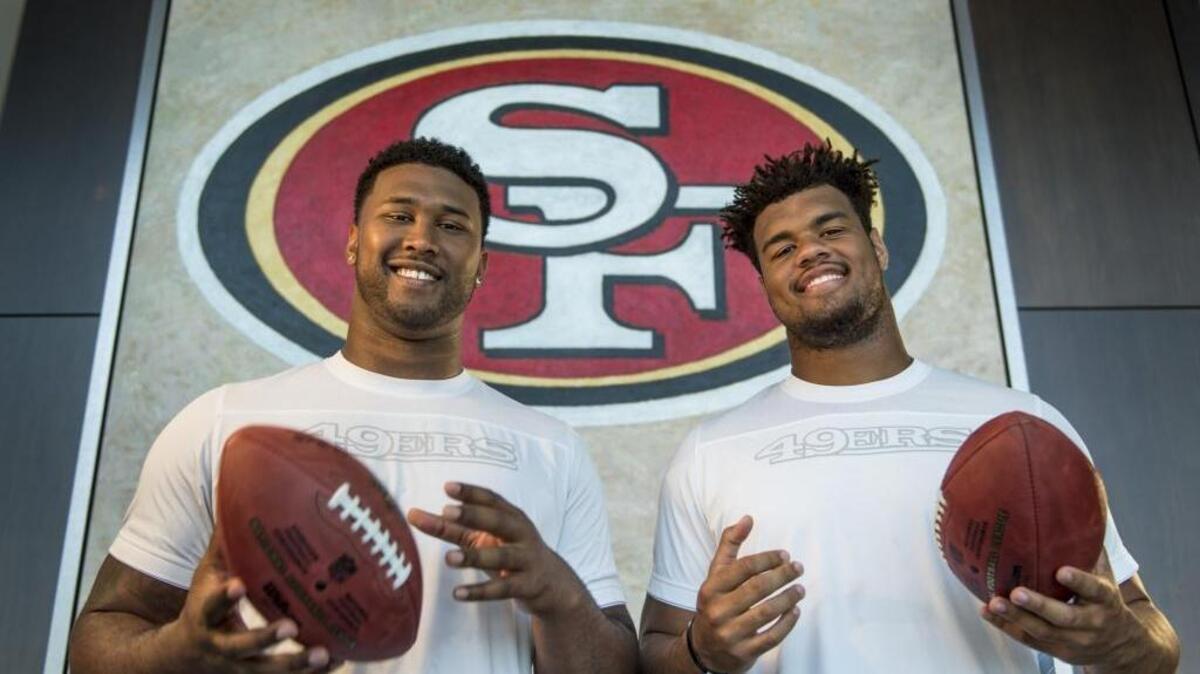 Defensive linemen DeForest Buckner, left, and Arik Armstead of the 49ers have a lot in common: They’re 6-foot-7 ex-prep basketball players who were teammates at Oregon.