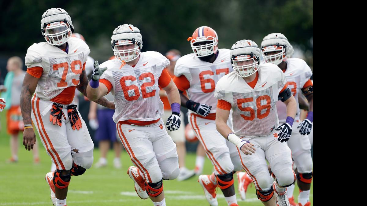 
Clemson offensive tackle Isaiah Battle (79), offensive guard Tyler Shatley (62) and offensive lineman Ryan Norton (58) runs drills during college football practice Monday, Dec. 30, 2013, at Barry University in Miami Shores, Fla. Clemson plays Ohio State in the Orange Bowl Jan. 3. 
