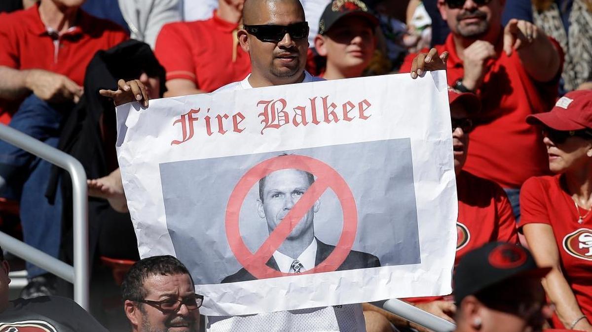 In this Oct. 23, 2016 photo, a fan holds up a sign of San Francisco 49ers general manager Trent Baalke during the first half of an NFL football game against the Tampa Bay Buccaneers in Santa Clara, Calif. The San Francisco 49ers have fallen to a new level of failure and futility, a laughingstock of the league.