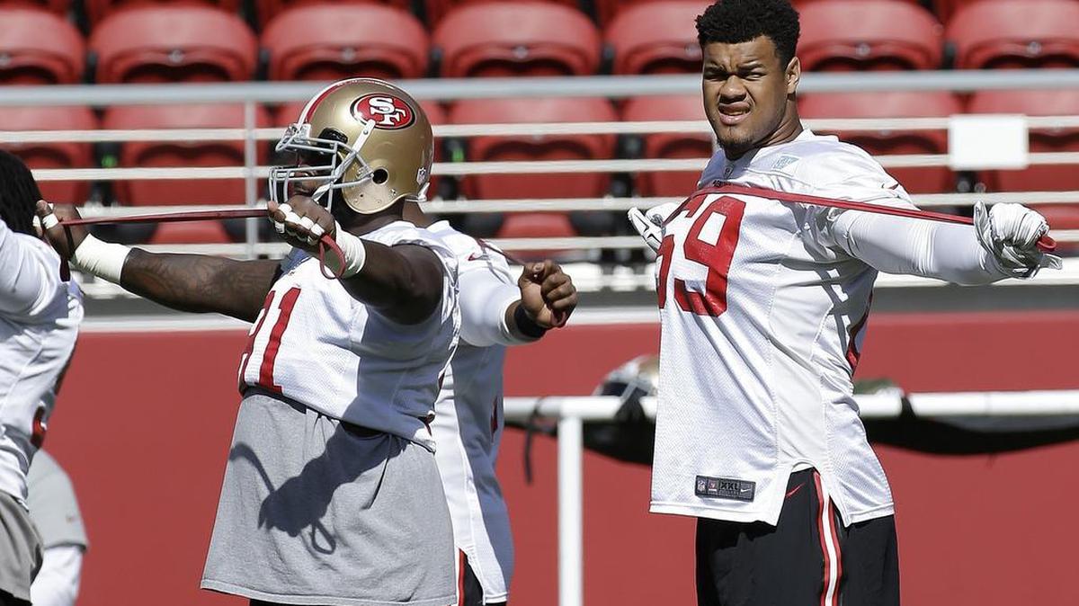 
San Francisco 49ers defensive linemen Glenn Dorsey, left, and Arik Armstead stretch during the team’s NFL football training camp in Santa Clara, Calif., Sunday, Aug. 2, 2015.
