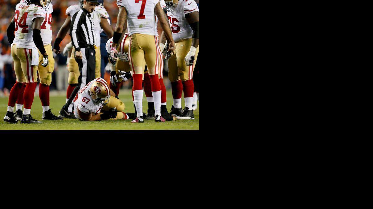 
San Francisco center Daniel Kilgore (67) lies on the field after suffering a broken ankle against the Denver Broncos during the first half Sunday. Rookie Dillon Farrell filled in but was then injured, too.
