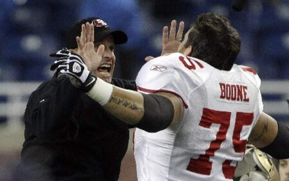 
Guard Alex Boone and Jim Harbaugh celebrate a 49ers win over the Lions in 2011.
