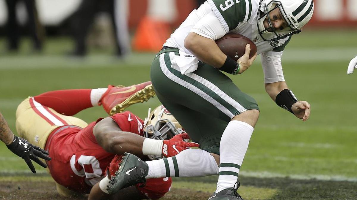 DeForest Buckner of the 49ers, left, tries to bring down Jets quarterback Bryce Petty in Santa Clara, Calif., on Sunday, Dec. 11, 2016.