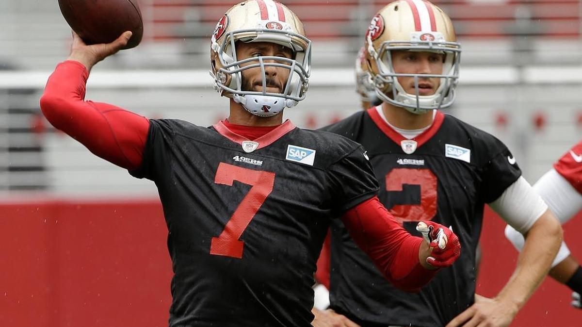 
San Francisco 49ers quarterback Colin Kaepernick (7) passes as Blaine Gabbert (2) watches during an NFL football mini-camp in Santa Clara, Calif., Wednesday, June 10, 2015. 
