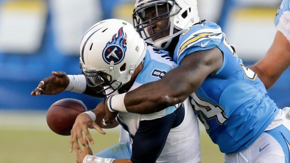 Tennessee Titans quarterback Marcus Mariota, left, drops the ball as he is brought down by San Diego Chargers outside linebacker Melvin Ingram during the second half of an NFL football game, Sunday, Nov. 6, 2016, in San Diego. The Chargers recovered the ball and scored a touchdown on the play.