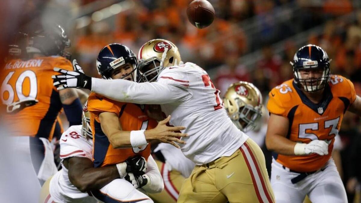 Denver Broncos quarterback Mark Sanchez fumbles as he is hit by San Francisco 49ers' Tank Carradine, lower left, and Garrison Smith, center, in the first half of a preseason NFL football game, Saturday, Aug. 20, 2016, in Denver.