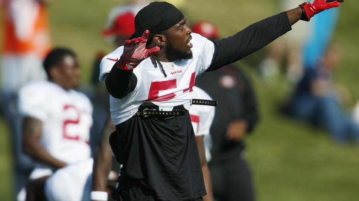 San Francisco 49ers outside linebacker Ray-Ray Armstrong sings as he stretches as players prepare to take part in drills against the Denver Broncos during the team's joint NFL football training camp session Thursday, Aug. 18, 2016, in Englewood, Colo.