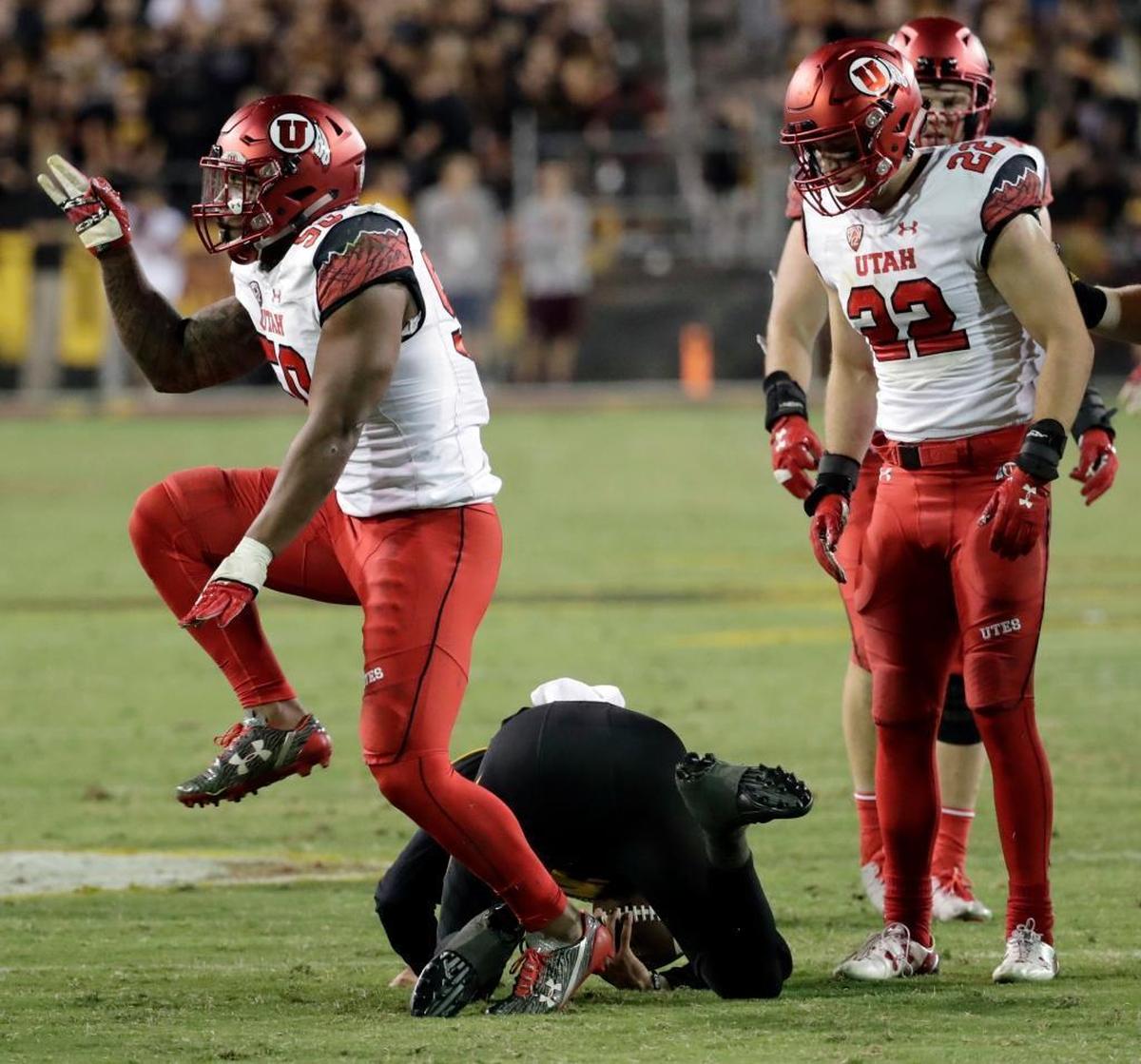 Utah defensive end Pita Taumoepenu, left, celebrates his sack as Arizona State quarterback Manny Wilkins remains on the turf Nov. 10, 2016, in Tempe, Ariz.