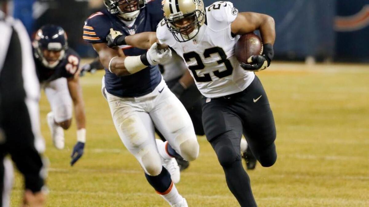 New Orleans Saints running back Pierre Thomas (23) carries the ball against Chicago Bears outside linebacker Jon Bostic (57) during the first half of an NFL football game Monday, Dec. 15, 2014, in Chicago. He is the second free-agent running back signed by the 49ers in a 24-hour period.