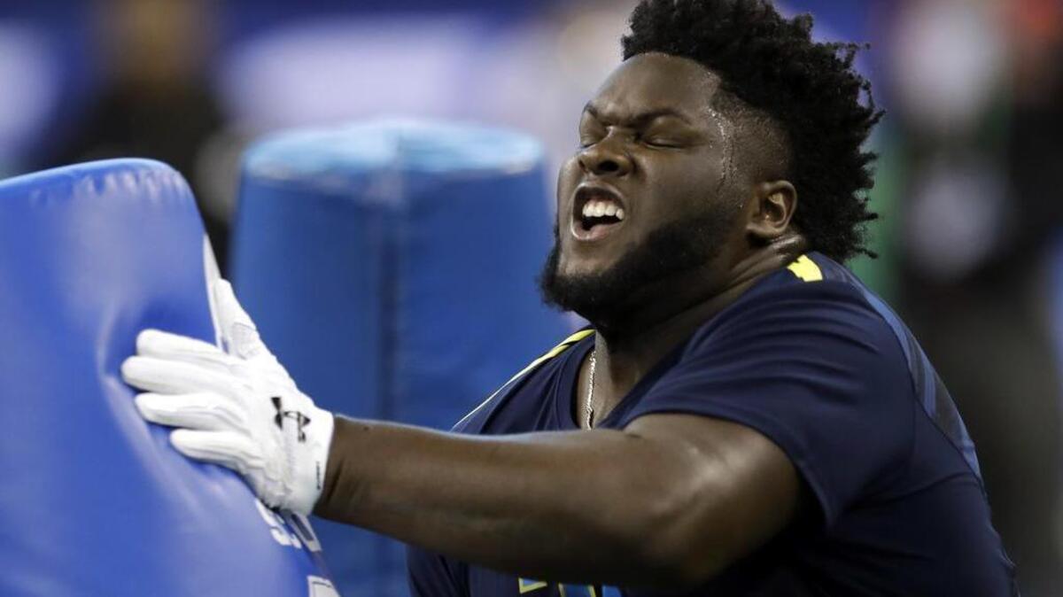 Mississippi defensive lineman D.J. Jones hits a blocking dummy during a drill at the NFL football scouting combine Sunday, March 5, 2017, in Indianapolis.
