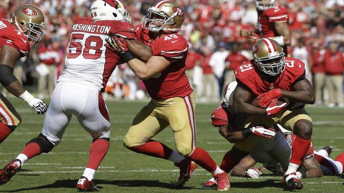 
Fullback Bruce Miller (49), opening a hole for Frank Gore last season against the Arizona Cardinals, has been a key to the 49ers’ offensive success. In Sunday night’s loss to the Denver Broncos, he participated in a low percentage of the team’s offensive plays.
