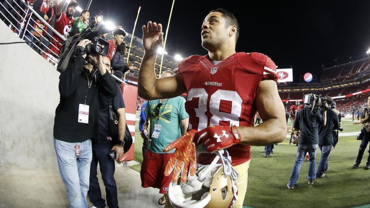 In this photo taken with a fisheye lens, San Francisco 49ers running back Jarryd Hayne (38) waves to fans after an NFL preseason football game against the San Diego Chargers in Santa Clara, Calif., Thursday, Sept. 3, 2015. The 49ers won 14-12.