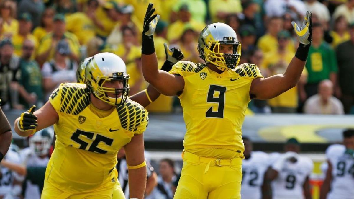 Oregon Alex Balducci, left, and Arik Armstead celebrate a defensive stop against Michigan State during the 1st quarter of their college football game in Eugene, Ore. Saturday Sept. 6, 2014.