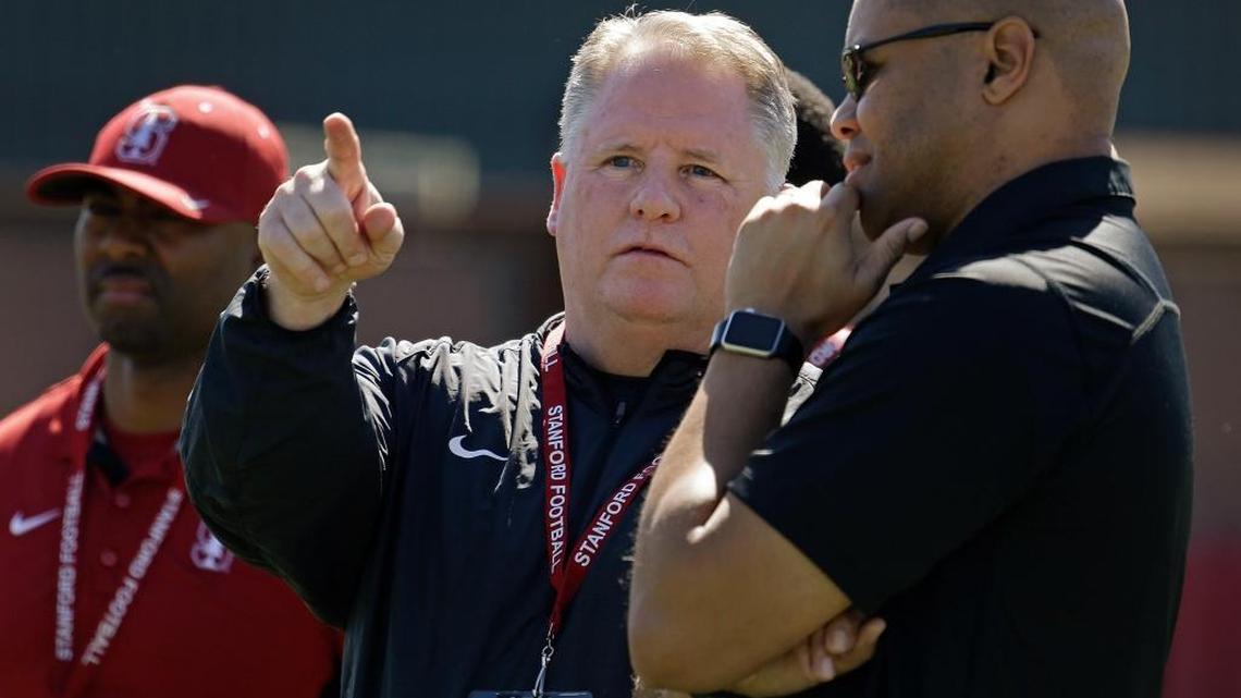 San Francisco 49ers' coach Chip Kelly, center, gestures beside Stanford football coach David Shaw, right, during Stanford's NFL Pro Day Thursday, March 17, 2016, in Stanford, Calif.